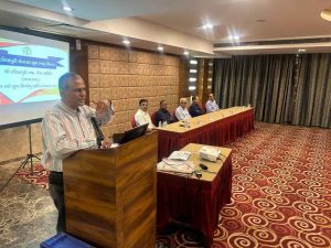 Speaker addressing youth during the Dariyapuri Sthanakwasi Jain Samiti Sneh Milan meeting at Hotel Planet Landmark, Ahmedabad.
